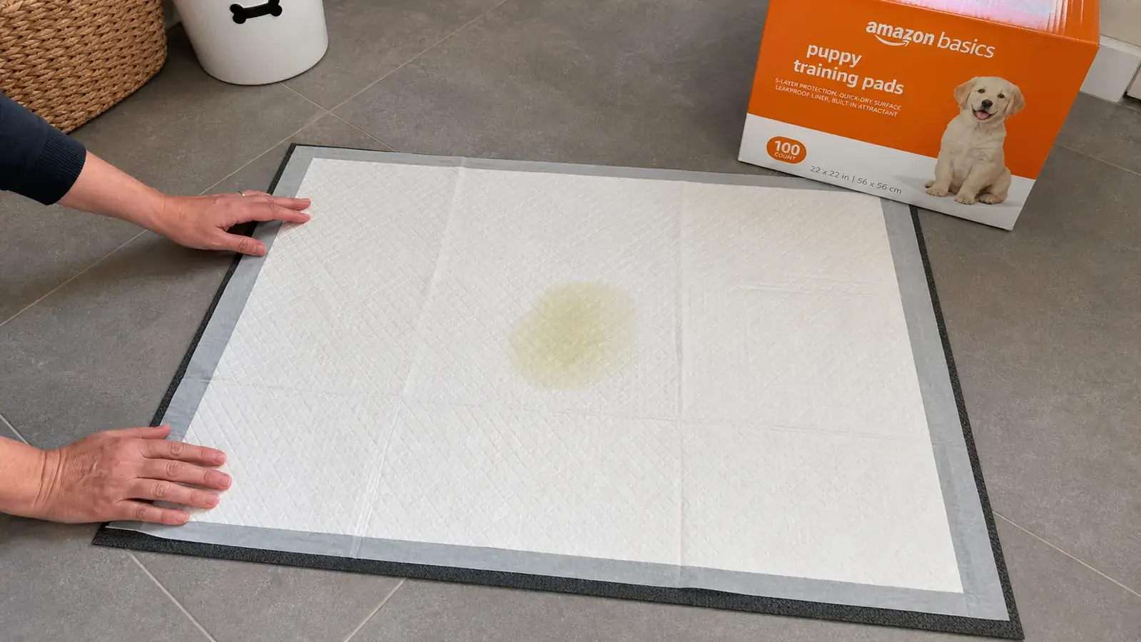 Puppy pad placed on tile floor with anti-slip mat underneath it