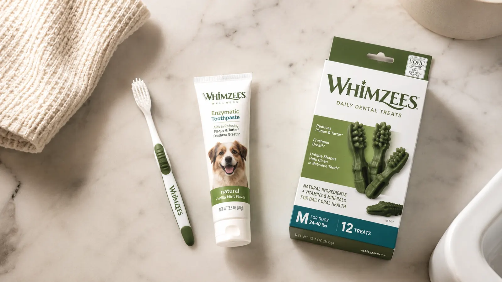 Dog toothbrush next to a box of dental chews on a bathroom counter showing a combined dental care approach